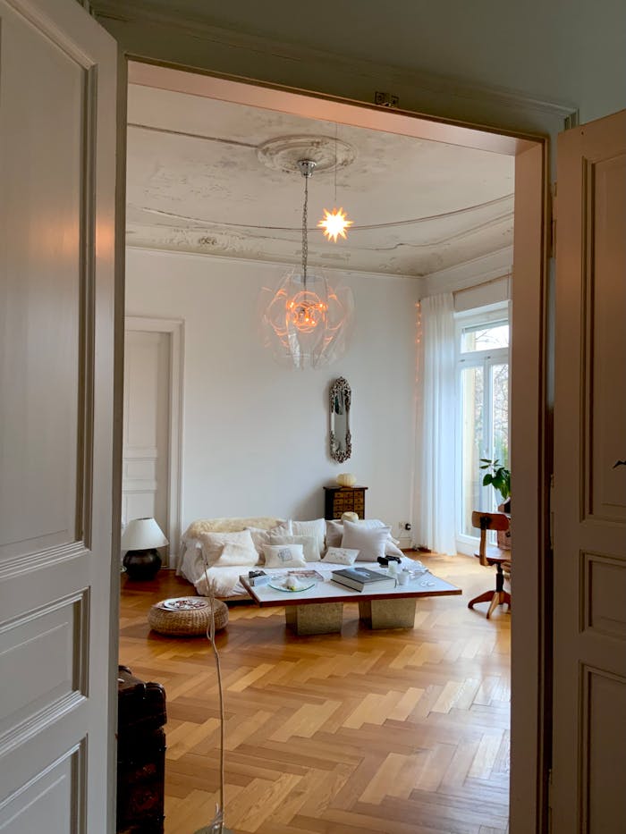 Minimalist living room interior with modern decor, wooden flooring, and warm lighting for a cozy atmosphere.