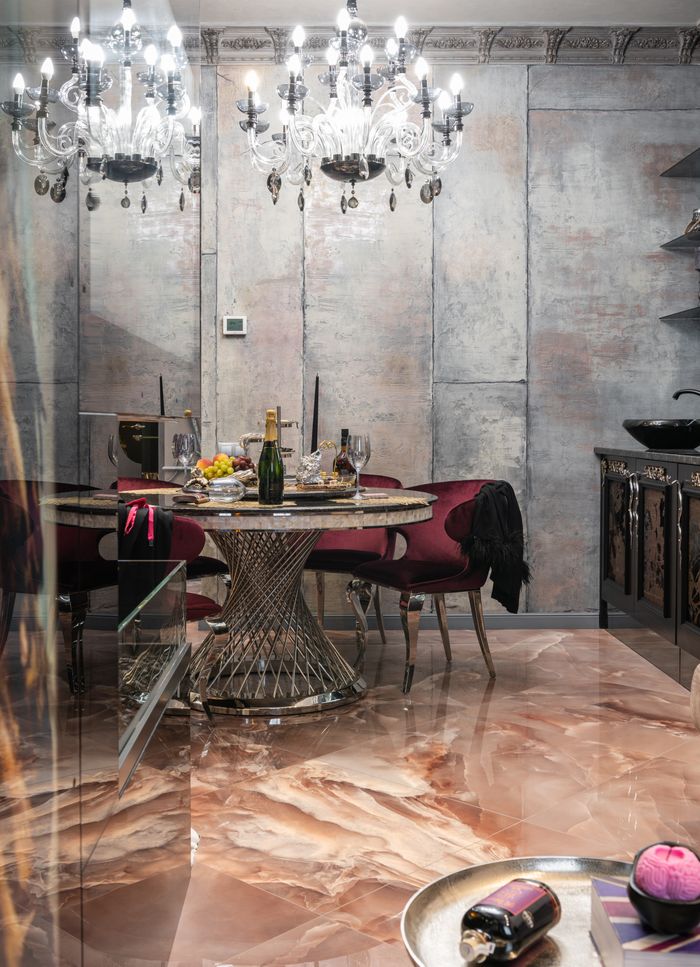 about-01 Modern interior design of spacious stylish kitchen with creative round dining table served for guests under shining chandelier