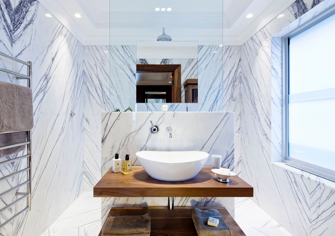 gallery-3 Contemporary bathroom design featuring marble walls and modern sink.